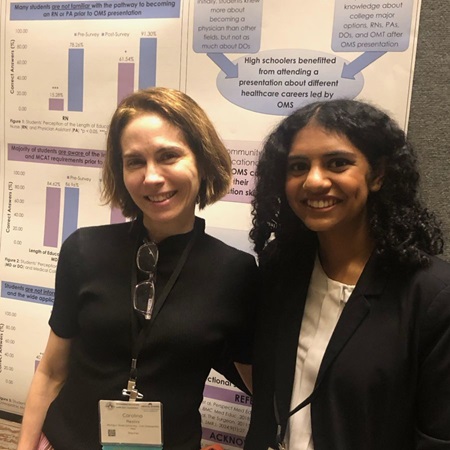 Viji Jambunathan (right) at a research poster presentation with Dr. Carolina Restini.
